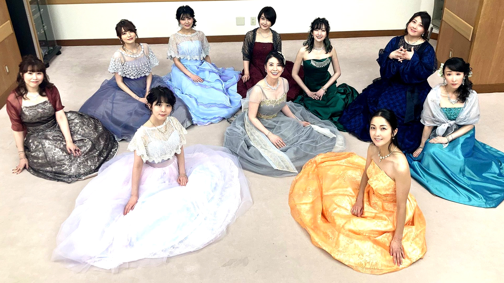 Photo of Sailor Moon Eternal Japanese voice actors in colourful dresses.