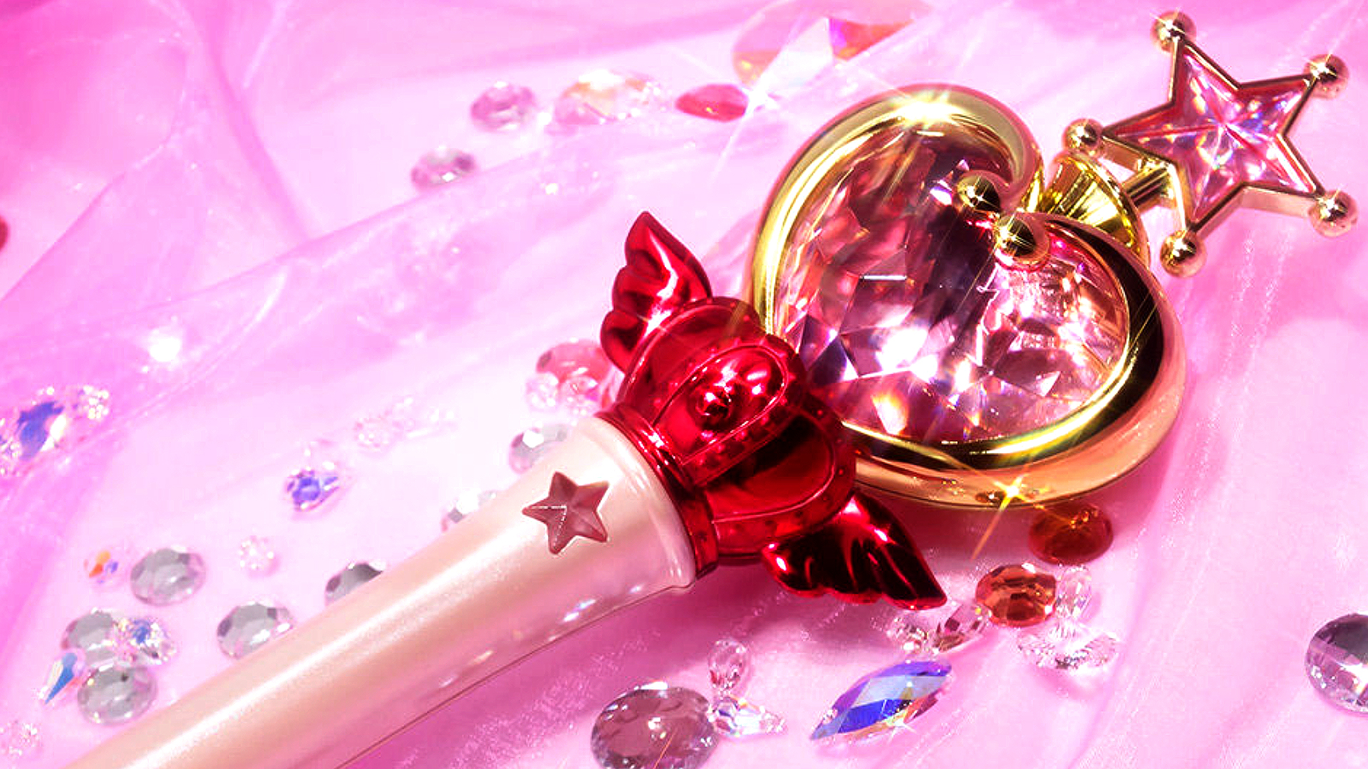 Sailor Chibi (Mini) Moon Pink Moon Stick Proplica on a pink blanket surrounded by crystal gems.