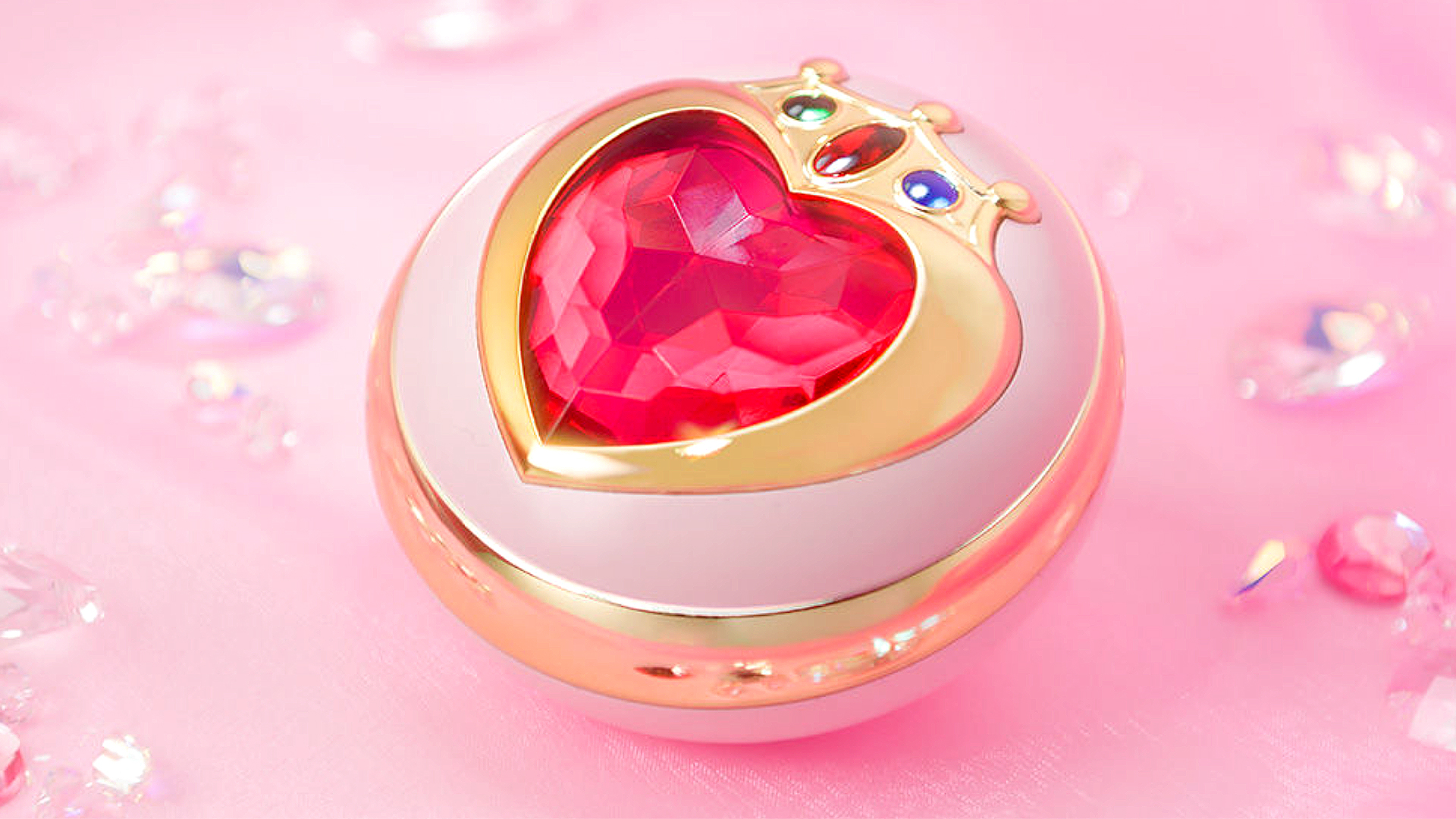 Sailor Mini Moon's Prism Heart Compact Proplica next to real pink crystals.